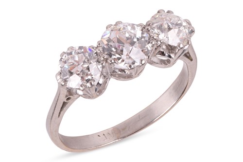 Lot 8 - An old-European cut diamond trilogy ring,...