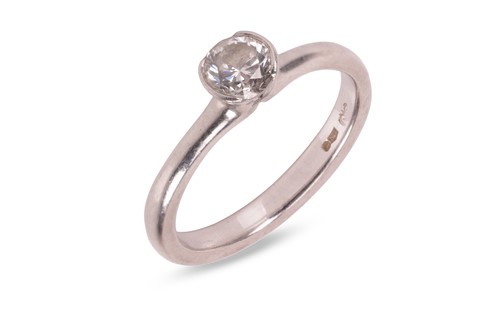 Lot A diamond solitaire ring, featuring a central...