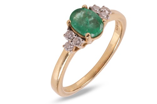 Lot 124 - An emerald and diamond ring, featuring a...