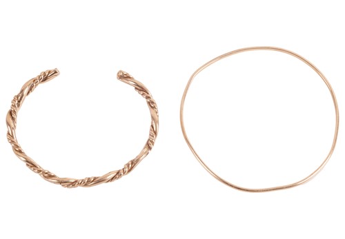 Lot 108 - Two bangles in 9ct yellow gold; the open...