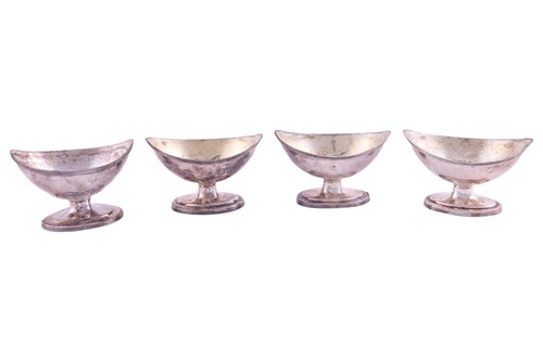 Lot A set of three George III silver salt cellars,...