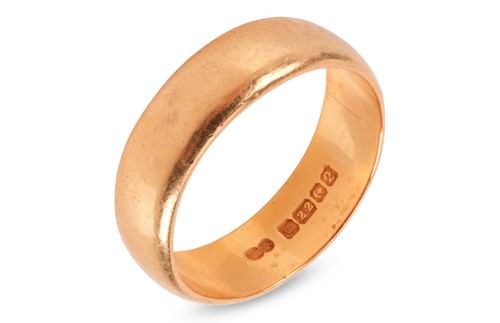 Lot 100 - A 22ct gold wedding band, the wide gold band...