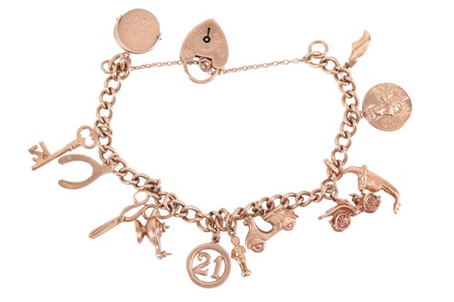 Lot 125 - A charm bracelet, including twelve charms with...
