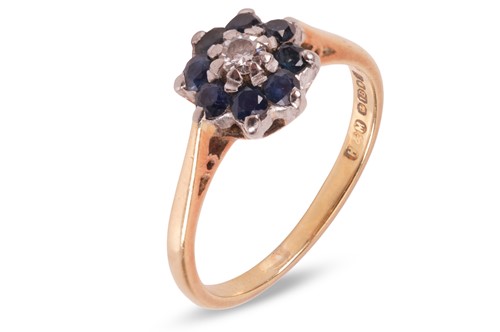 Lot 105 - A sapphire and diamond cluster ring, featuring...