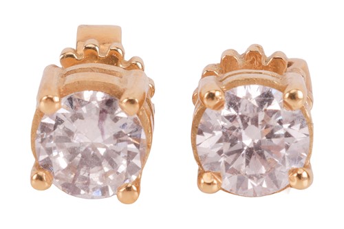 Lot 145 - A pair of single stone diamond earrings, the...