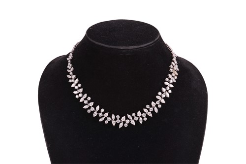 Lot A diamond-set necklace of abstract foliate...