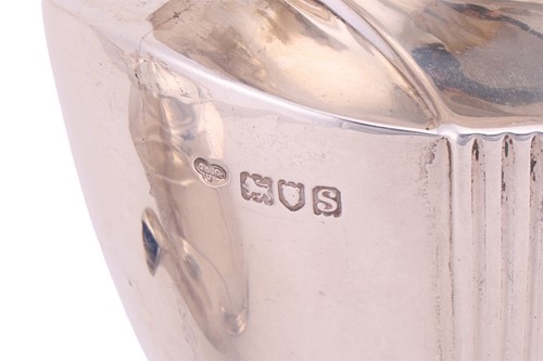 Lot A four piece silver tea service; comprising a...