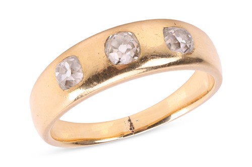 Lot 6 - A diamond three-stone gypsy ring, featuring...