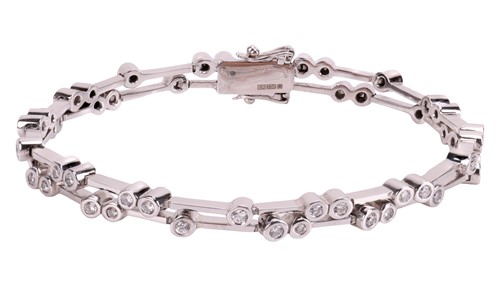 Lot 189 - A diamond-set bracelet, comprising two rows of...