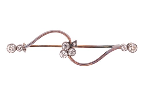 Lot 55 - A diamond-set foliate bar brooch, featuring a...