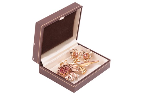 Lot 90 - A floral brooch and matching earrings set with...