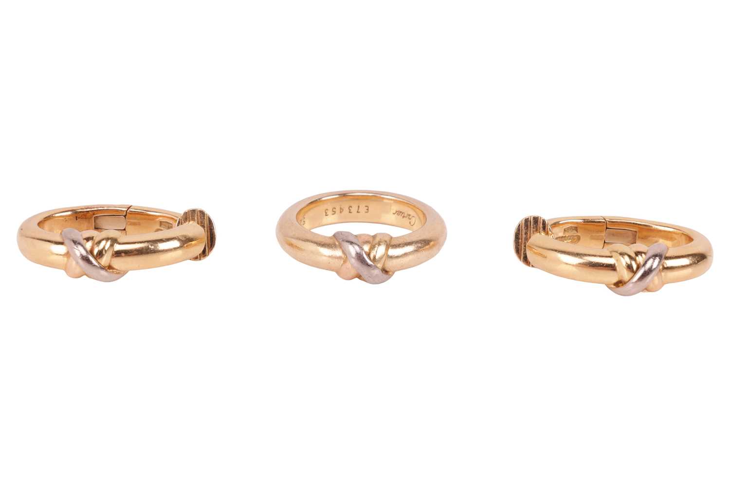 Lot 211 - Cartier - A trinity ring and clip earrings set;...