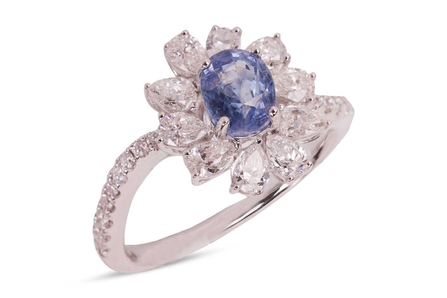 Lot 190 - A Kashmir sapphire and diamond cluster ring,...