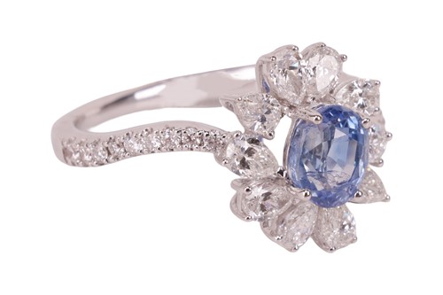 Lot 190 - A Kashmir sapphire and diamond cluster ring,...