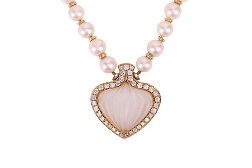 Lot 118 - A frosted rock crystal pendant on a cultured...