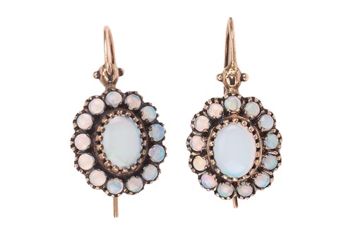 Lot 51 - A pair of opal drop earrings; each featuring a...