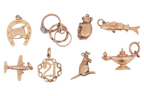 Lot 34 - A collection of eight charms; to include five...