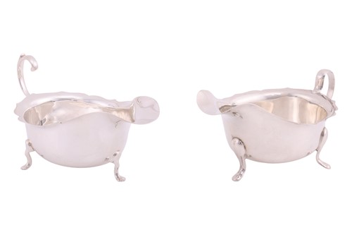 Lot 234 - A silver sauceboat with shaped rim and flying...
