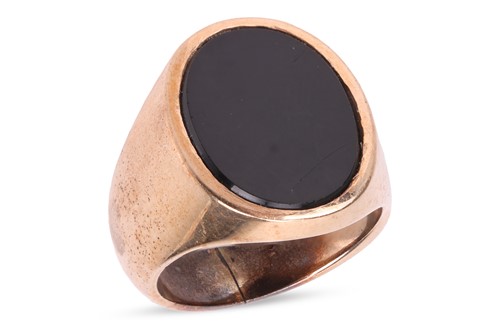 Lot 25 - An onyx signet ring, featuring a central...