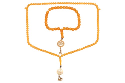 Lot 89 - Two imitation amber necklaces; the first...