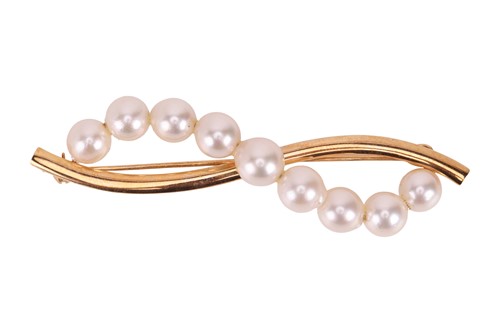 Lot A pearl set brooch, set with a scrolling row...