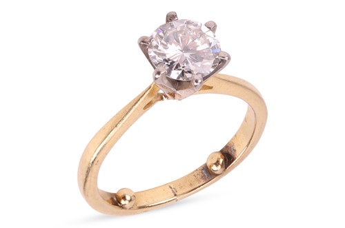 Lot A diamond solitaire ring, featuring a round...