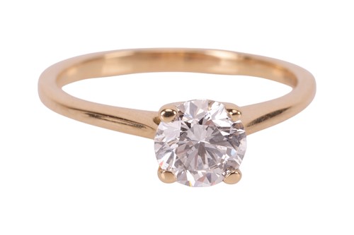 Lot A diamond solitaire ring, featuring a central...