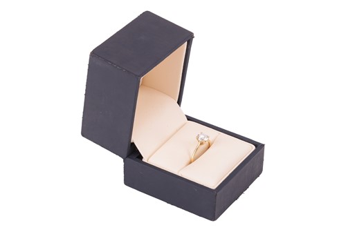 Lot A diamond solitaire ring, featuring a central...