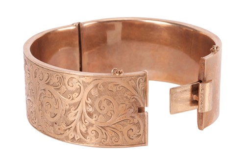 Lot A 9 carat gold bangle, the hinged bangle with...