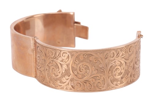 Lot A 9 carat gold bangle, the hinged bangle with...