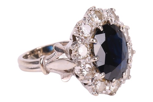 Lot A sapphire and diamond cluster ring, centred...