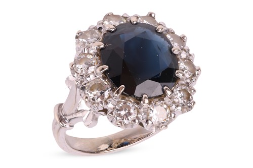 Lot A sapphire and diamond cluster ring, centred...