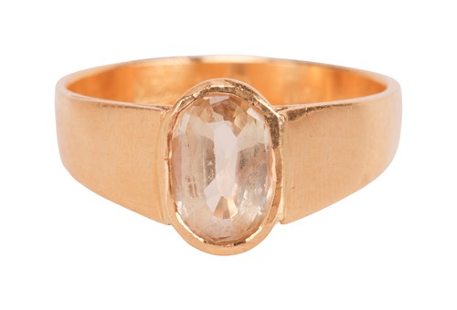Lot A yellow sapphire ring, the oval-cut yellow...