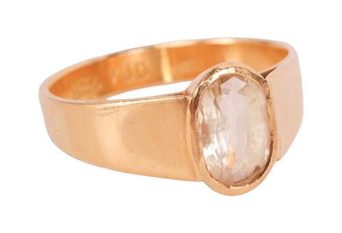 Lot A yellow sapphire ring, the oval-cut yellow...