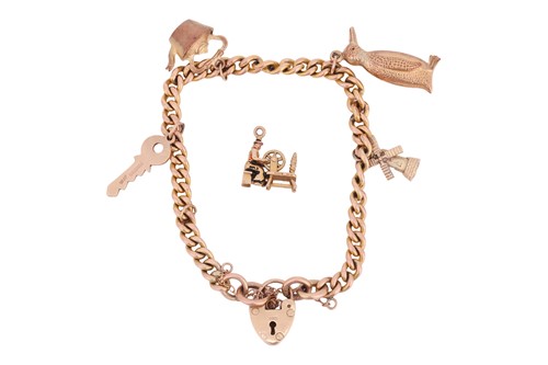 Lot A 9ct gold charm bracelet, the curb link chain...