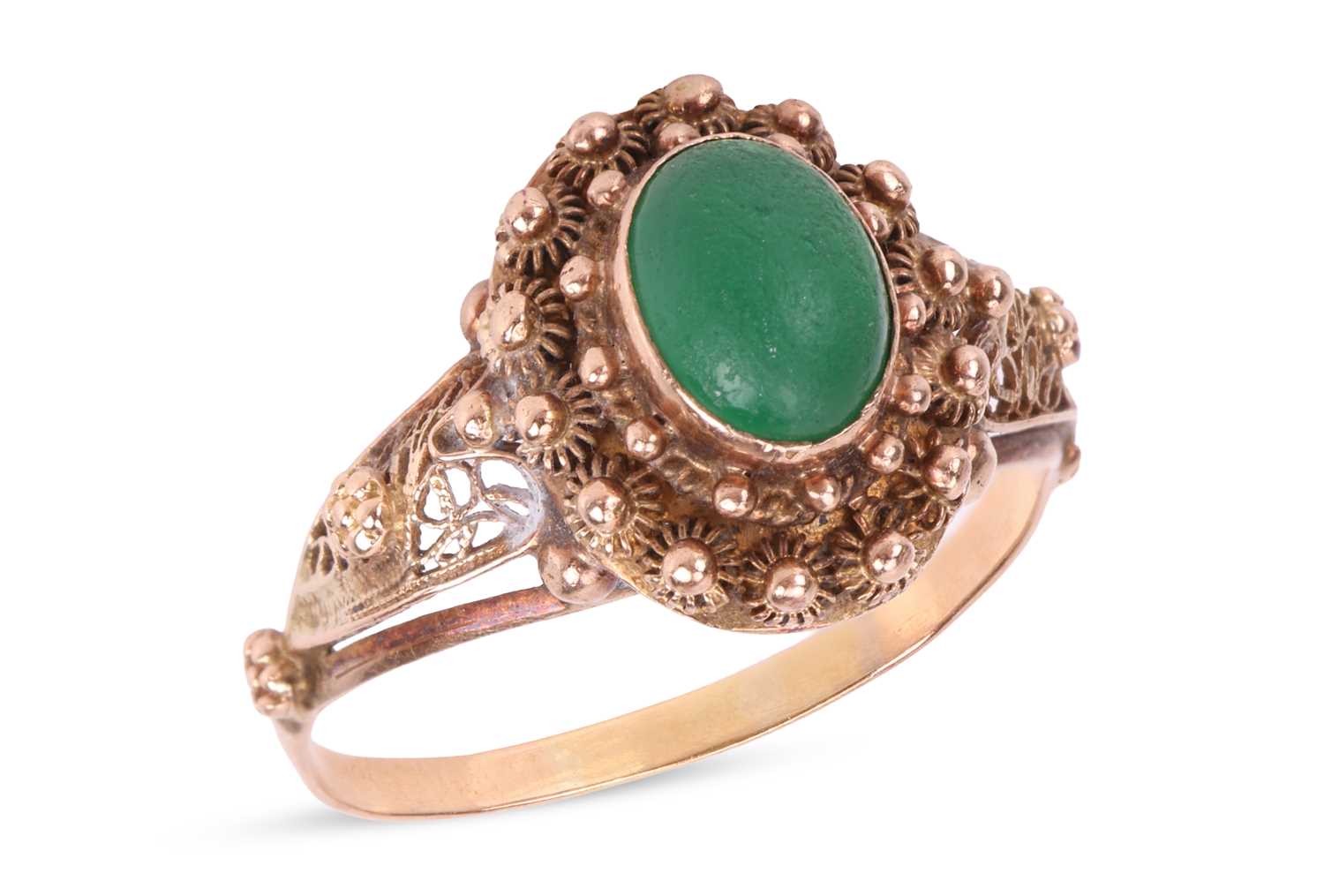 Lot A green paste ring, centrally-set with an oval...