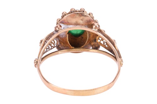 Lot A green paste ring, centrally-set with an oval...