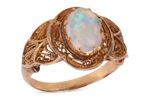 Lot An opal ring, the oval cabochon opal in a...