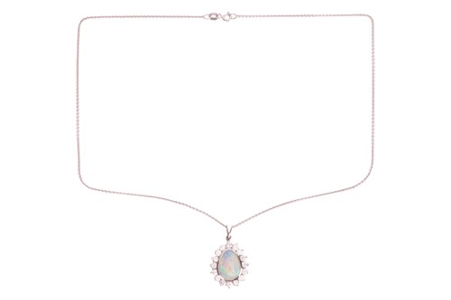 Lot An opal and diamond cluster pendant, the...